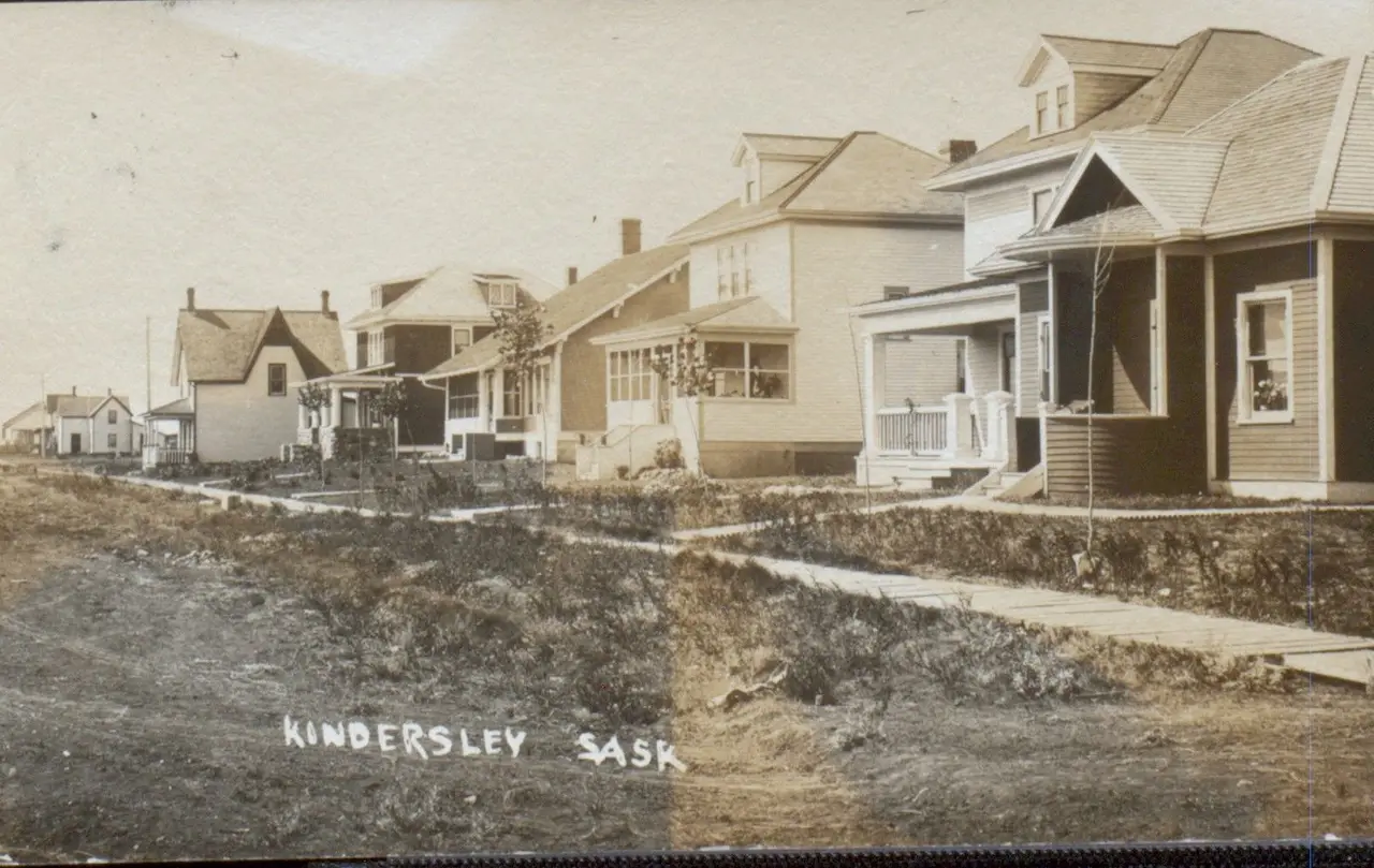 Residential street with houses and wooden sidewalk, about 1912