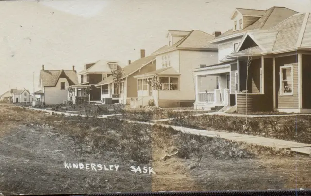 Residential street with houses and wooden sidewalk